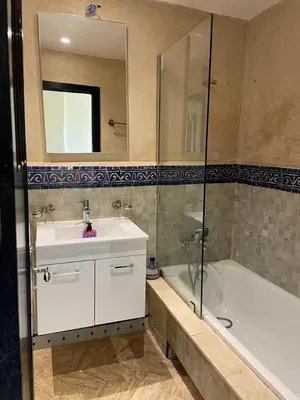 a bathroom with a sink and a tub and a mirror at Strasmarrakech in Marrakech