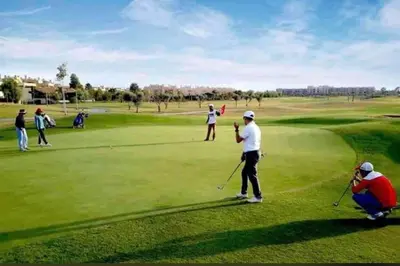 a group of people playing golf on a golf course at Prestigia Golf entrée Agate (wifi) in Marrakech