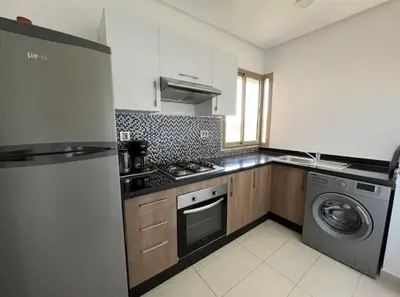 a kitchen with a stove and a washing machine at Prestigia Golf entrée Agate (wifi) in Marrakech