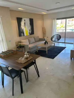 a living room with a couch and a table at Prestigia Golf entrée Agate (wifi) in Marrakech