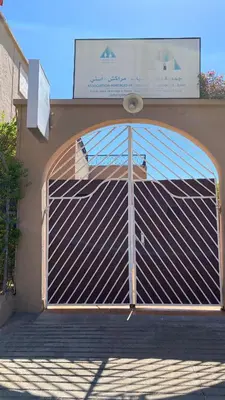 a metal gate on the side of a building at Auberge de Jeunesse Marrakech-Asni in Marrakech