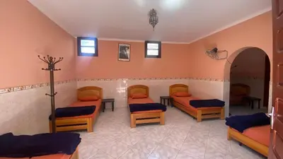 a room with three beds in a room at Auberge de Jeunesse Marrakech-Asni in Marrakech