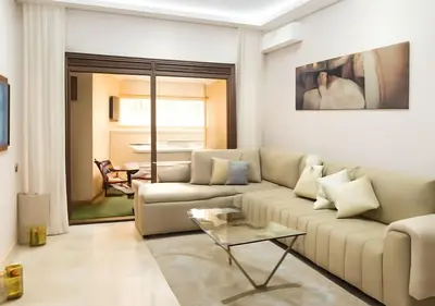 a living room with a couch and a table at Appart vacance safaa in Marrakech