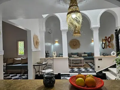 a living room with a bowl of fruit on a table at Riad karya MEDINA in Marrakech