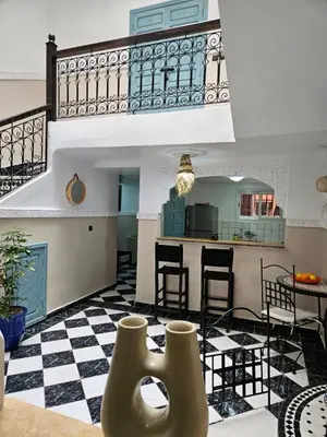 a living room with a black and white checkered floor at Riad karya MEDINA in Marrakech