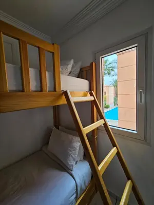 a bunk bed in a room with a window at Riad karya MEDINA in Marrakech