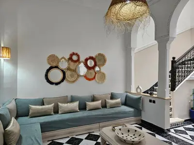 a living room with a blue couch and some mirrors at Riad karya MEDINA in Marrakech