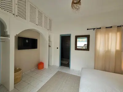 a bedroom with a bed and a tv on a wall at Riad karya MEDINA in Marrakech