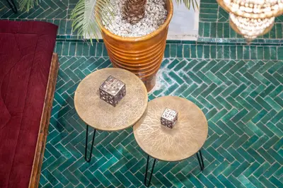 two tables with chocolate on them on a floor at Riad Dekkak, Maison complète en exclusivité in Marrakech