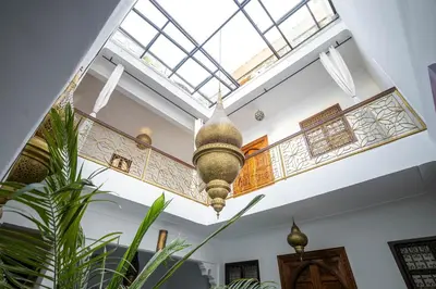a ceiling light in a room with plants at Riad Dekkak, Maison complète en exclusivité in Marrakech