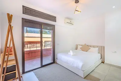 a bedroom with a bed and a ladder at modern friendly appt in gueliz in Marrakech