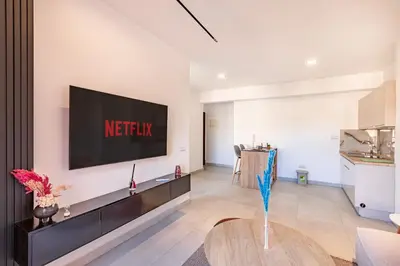 a living room with a television on a wall at modern friendly appt in gueliz in Marrakech
