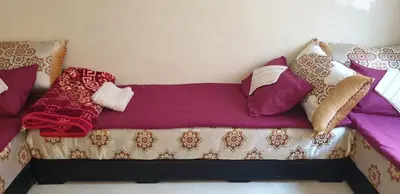 a couch with pillows on it in a room at Mabrouka in Marrakech