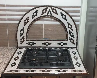 a kitchen with a stove with a mirror above it at Mabrouka in Marrakech