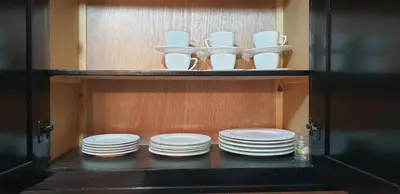 a cabinet with white plates and bowls in it at Mabrouka in Marrakech