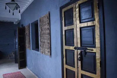 an open door in a room with a blue wall at Riad Dar Alamane in Marrakech