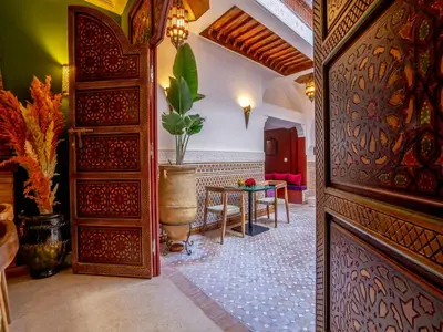 a hallway with a table and a room with a building at Riad Kilimini & SPA in Marrakech
