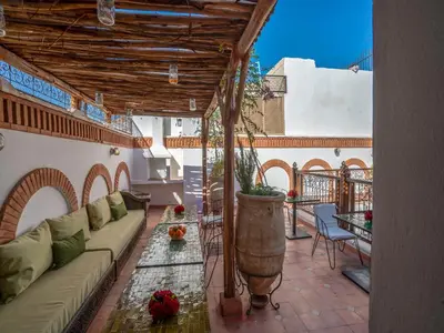a living room with a couch and a table at Riad Kilimini & SPA in Marrakech