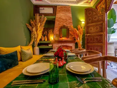 a dining room with a table with plates and utensils at Riad Kilimini & SPA in Marrakech