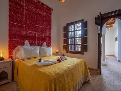 a bedroom with a bed with two babies laying on it at Riad Kilimini & SPA in Marrakech