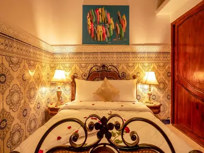 a bedroom with a bed and two lamps in it at Pretty Apartment in the Medina in Marrakech