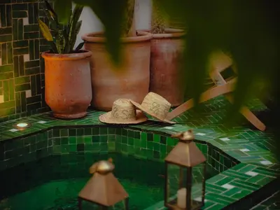 a group of potted plants and hats on a counter at Riad La Smala in Marrakech
