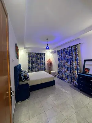 a bedroom with a bed and curtains in a room at Appartements Guéliz Zerktouni in Marrakech