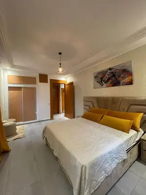 a bedroom with a large bed with yellow pillows at Appartements Guéliz Zerktouni in Marrakech