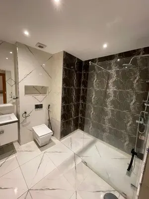 a bathroom with a toilet and a shower and a sink at Appartements Guéliz Zerktouni in Marrakech