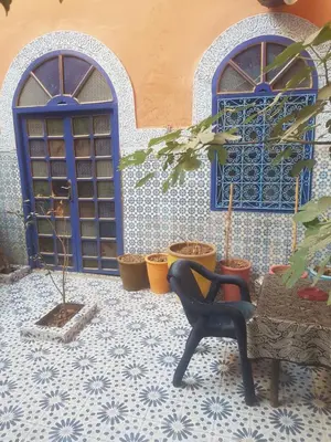 a room with two blue doors and potted plants at Riad dar kader C in Marrakech