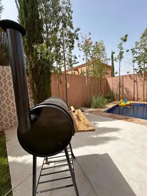 a black chair sitting in front of a pool at Villa djelloul s in Marrakech