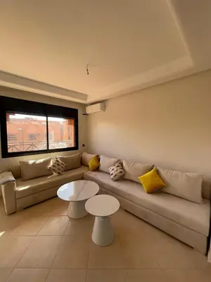 a living room with a couch and two tables at Appartement Moderne Premium in Marrakech