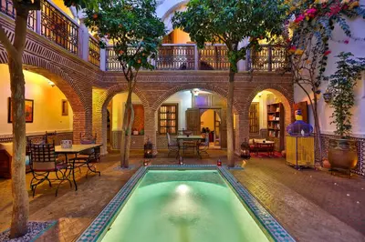 a house with a pool in the middle of a building at Riad Fleur d'Orient in Marrakech