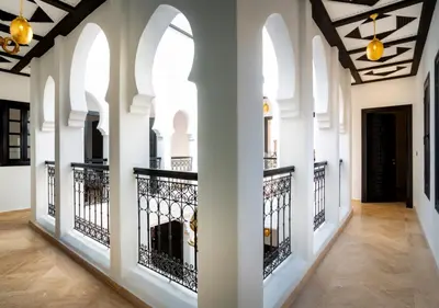 a hallway of a house with white walls and ceilings at Riad Tamazgha in Marrakech