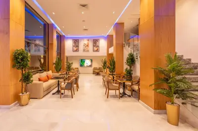 a lobby of a hotel with tables and chairs at Appart Hôtel Rambla in Marrakech