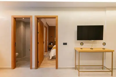 a living room with a television and a table at Appart Hôtel Rambla in Marrakech