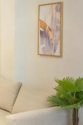 a living room with a couch and a picture on the wall at Appart Hôtel Rambla in Marrakech