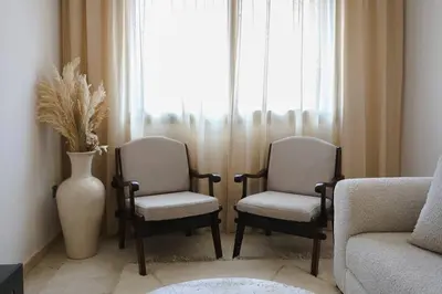 a living room with two chairs and a couch and a vase at Art Elegance – Downtown in Marrakech