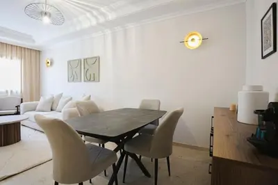a living room with a dining room table and chairs at Art Elegance – Downtown in Marrakech