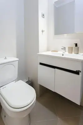 a white bathroom with a toilet and a sink at Art Elegance – Downtown in Marrakech
