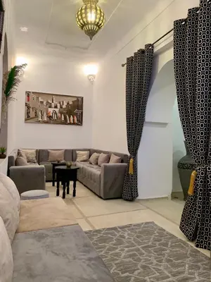 a living room with a couch and a table at Riad Rosita 4 chambres in Marrakech