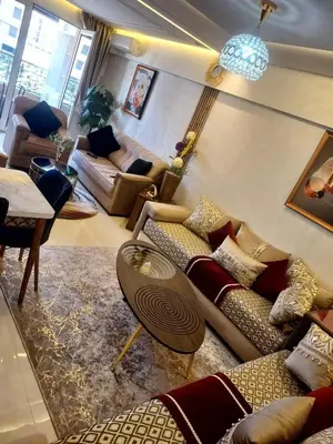 a living room with couches and a table at Calista Appart hotel piscine in Marrakech