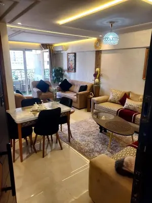 a living room with a couch and a table at Calista Appart hotel piscine in Marrakech