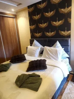 a large bed with two pillows on top of it at Calista Appart hotel piscine in Marrakech