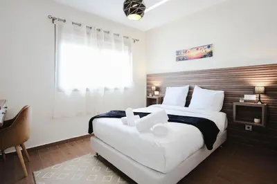 a bedroom with a large bed and a window at La Dolce Casa – Private Pool in Marrakech