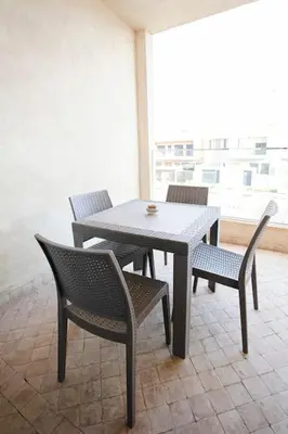 a table and two chairs and a white table and chairs at La Dolce Casa – Private Pool in Marrakech