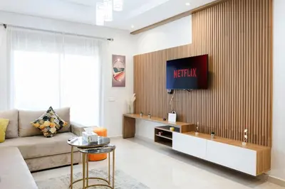a living room with a couch and a tv on a wall at La Dolce Casa – Private Pool in Marrakech