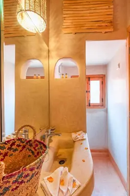 a bathroom with a sink and a bath tub at Riad Mama in Marrakech