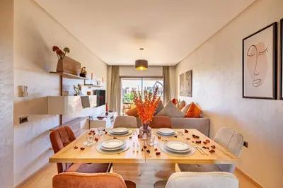 a dining room with a table and chairs at Perle Rare A Prestigia 2 Ch Avec Vue Incroyable in Marrakech