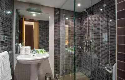 a bathroom with a sink and a glass shower at Yaad City Hotel in Marrakech